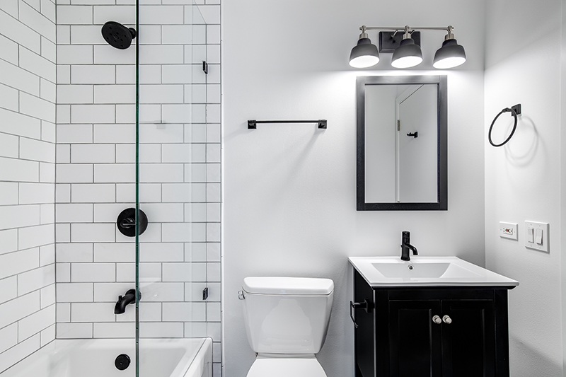 bathroom with white subway tiles mixed with black hardware